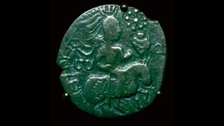 Silver coin of the Huns copying an Indian style, 5th century B.C. It has a picture of a person riding a horse on one side.