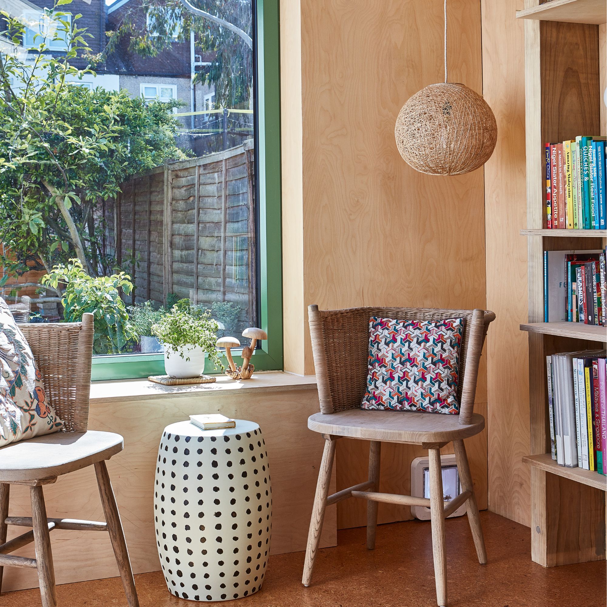 A plywood space with chairs, a coffee table and green accent