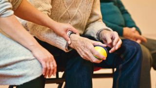 Young person holds older persons hands