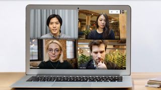 Four people on video call on laptop screen