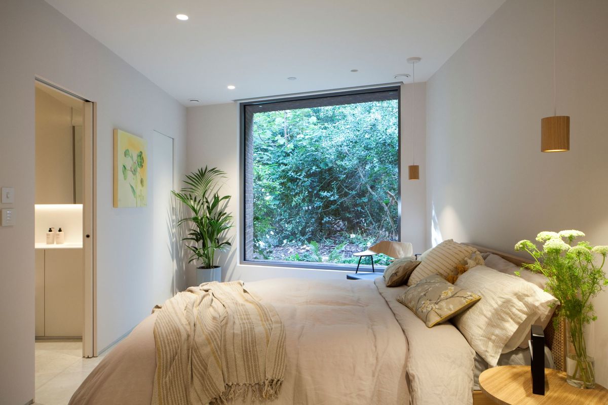 The bedroom of the triangle Grand Designs home with a large double bed