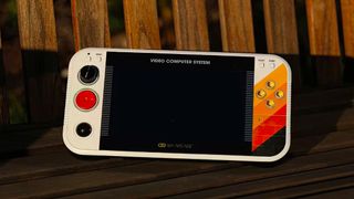 MyArcade Gamestation Portable; a retro handheld console on a park bench