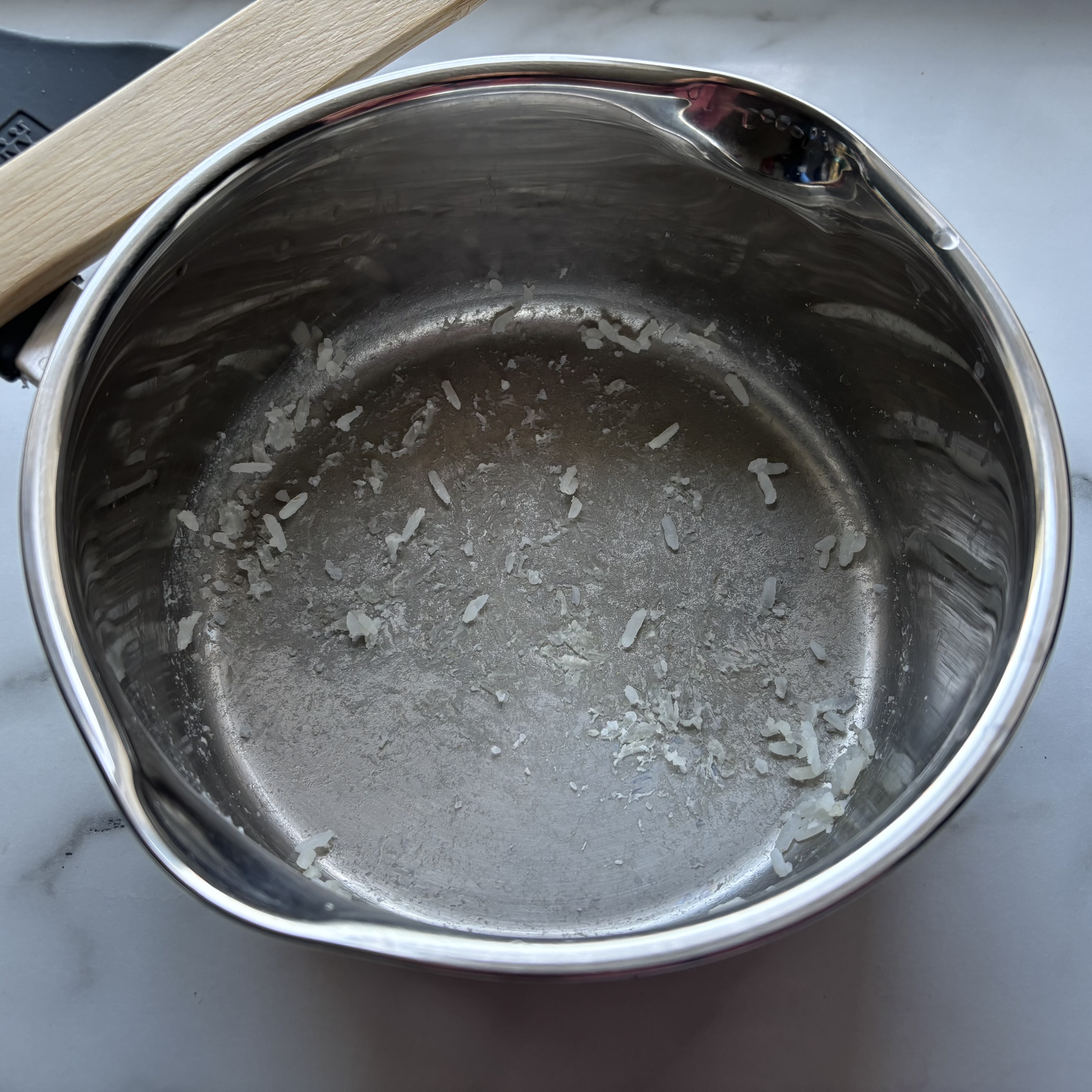 The Zwilling Simplify saucepan covered in the remnants of cooked rice.
