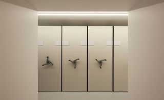 Vault-like storage with handles which are turned to move the storage racks