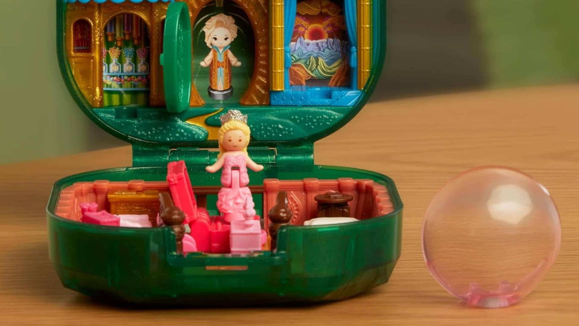 Image showing the inside of the Polly Pocket Wicked Compact, with the Glinda toy sitting inside.