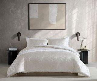 Vera Wang Queen Duvet Cover Set against a gray wall.