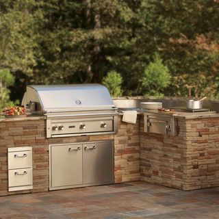 outdoor ovens on brick worktops with steel drawers
