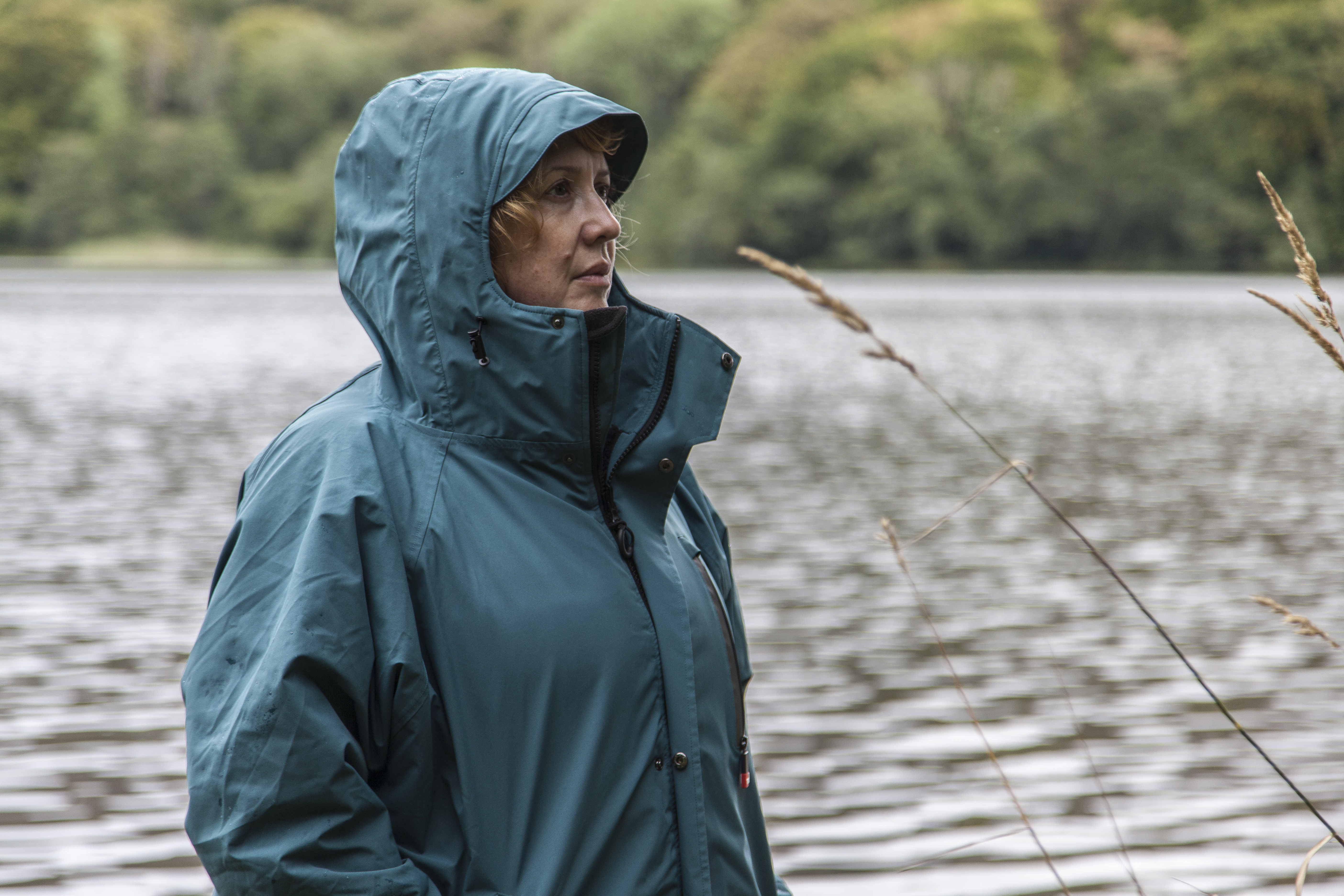 woman wearing Red Alter Evo standing on the banks of Grasmere lake in the Lake District