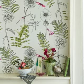 wall with leafy wallpaper and pot