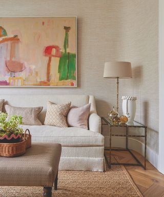 living room with fabric sofa in cream and jute rug