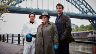 DCI Vera Stanhope (Brenda Blethyn), Dr Bennett (Sara Kameela Impey) and DS Aiden Healy (Kenny Doughty) in front of a bridge for Vera season 12