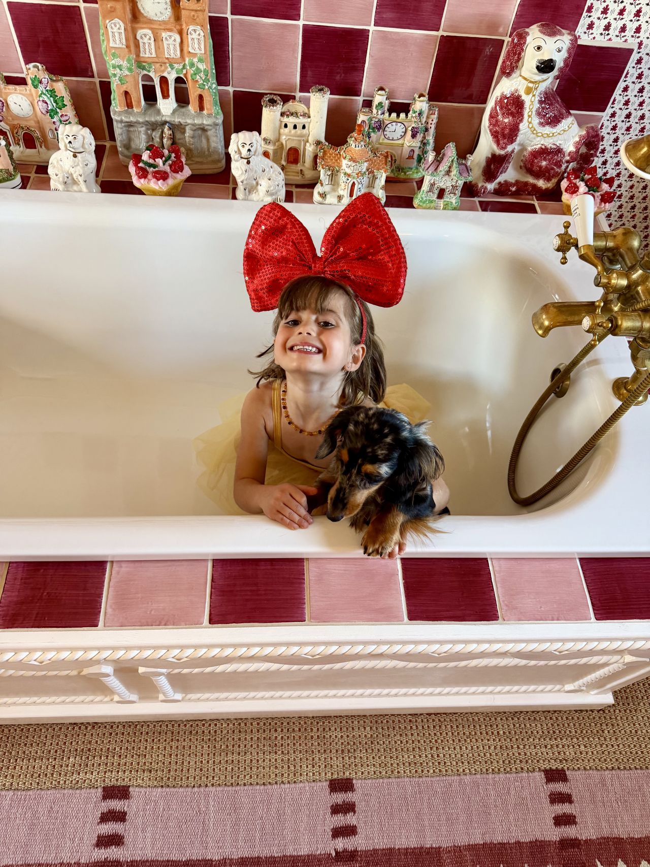 child in bath with dog