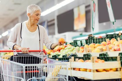 Woman Buying Organic Fruits In Local Supermarket. 