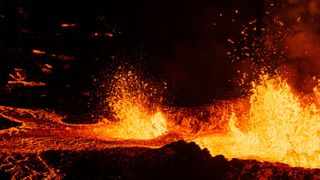 Molten lava is coming out from a fissure