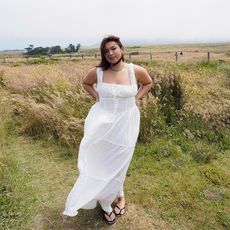 marina wears white dress in field 