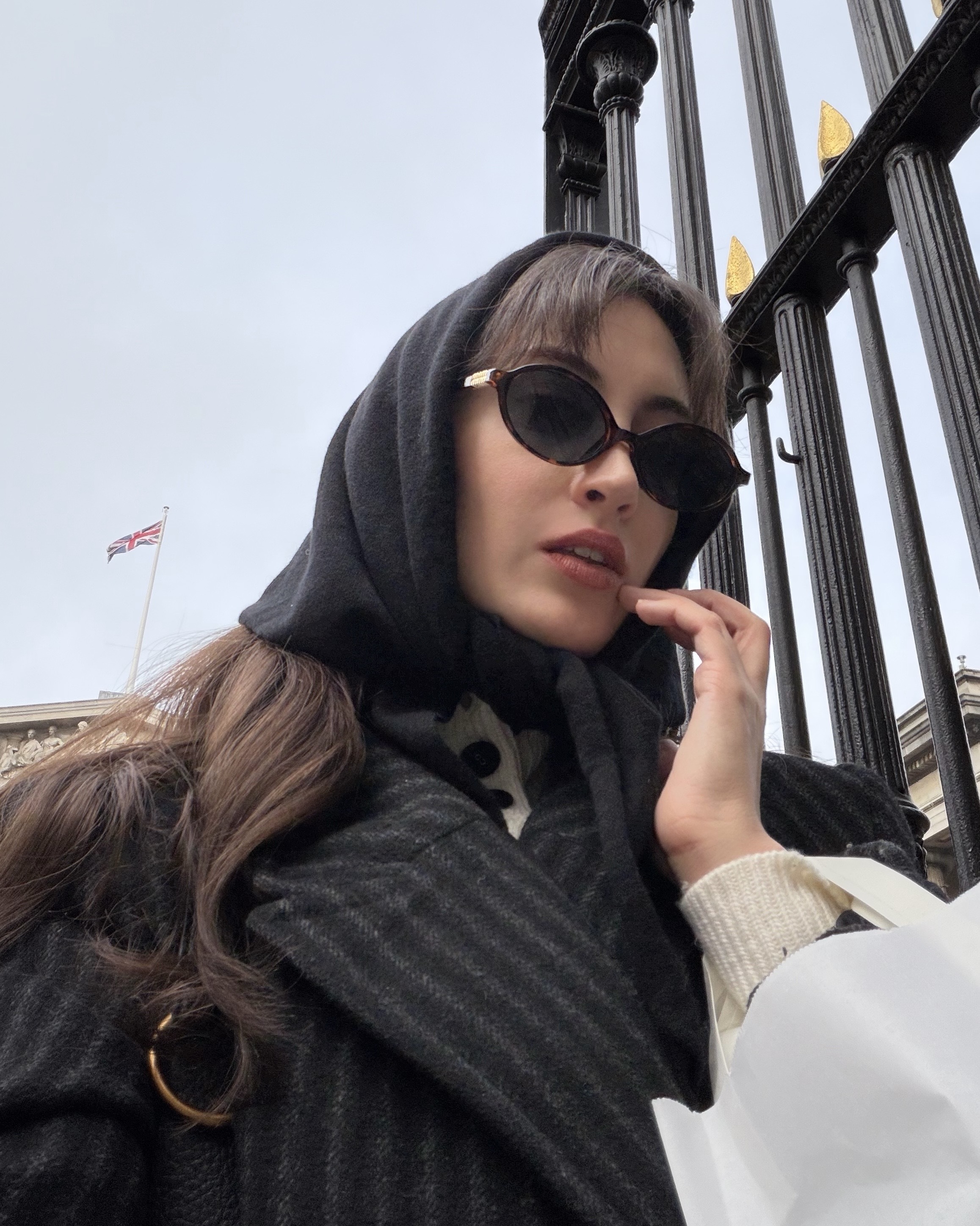 An image of Alyssa Brascia wearing a head scarf and sunglasses in London.