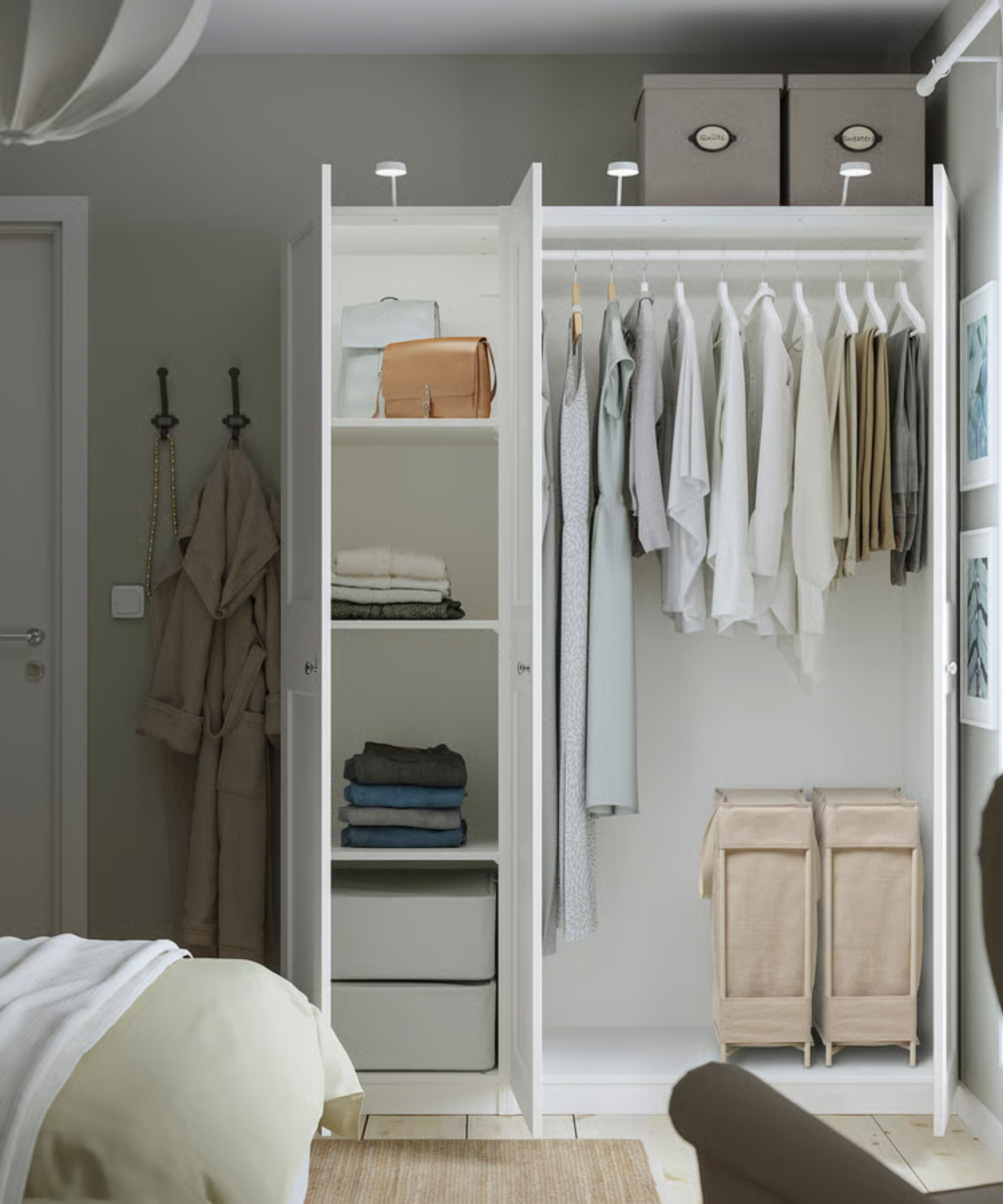 a bedroom with a large wardrobe with clothing inside, two laundry baskets on the floor, and a row of shelves holding clothing and accessories