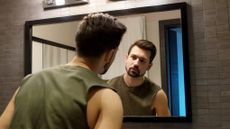 Man looking in mirror body image