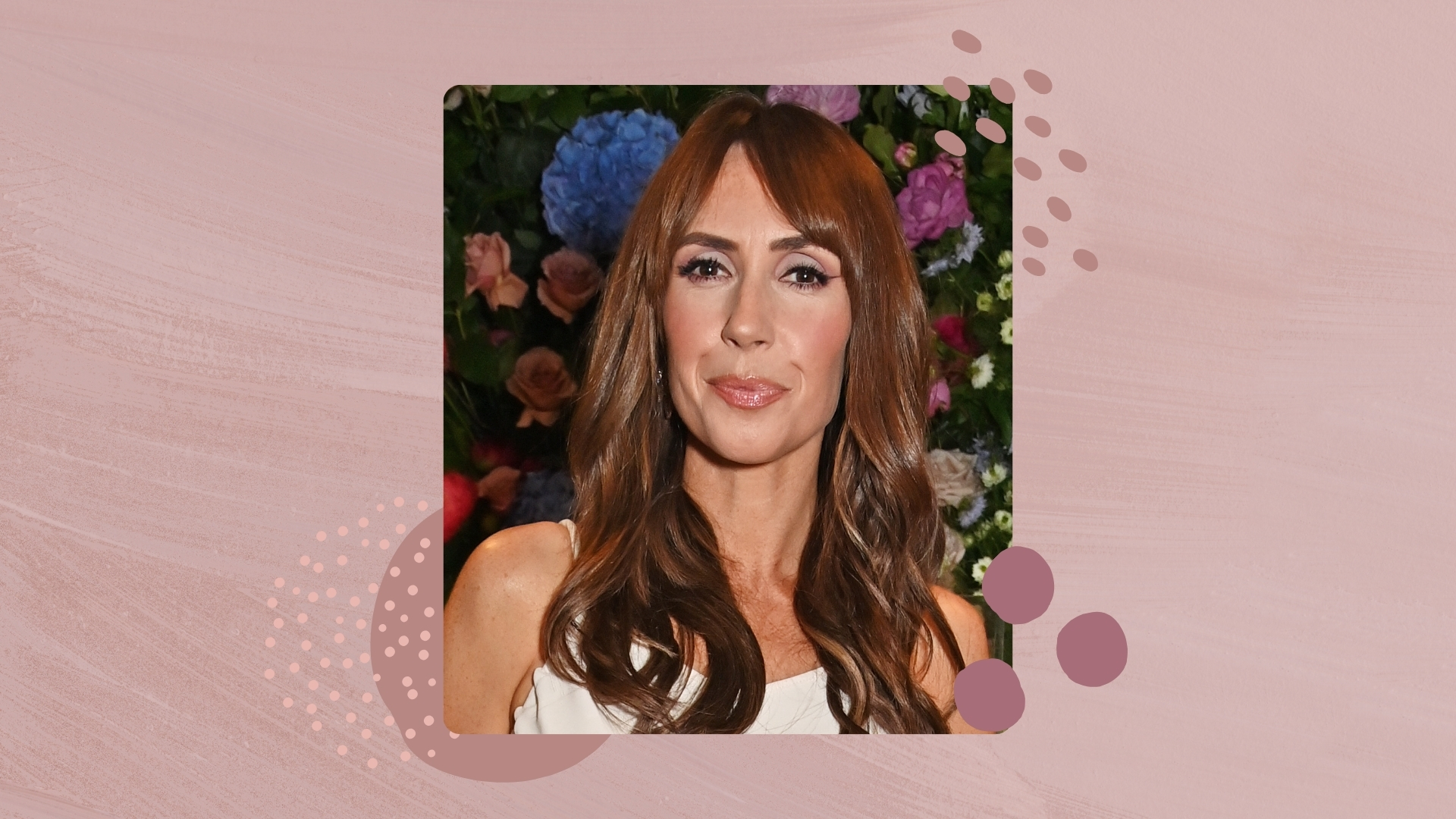 Image of Alex Jones smiling with curly brunette hair on a mauve background with purple dotty graphics