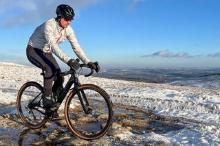 Male cyclist riding across an icy puddle on a gravel bike wearing Sidi Algor shoes