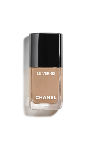 A bottle of tan Chanel nail polish against a white background.
