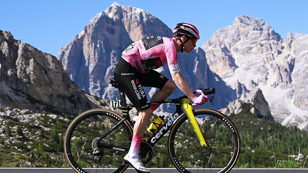 Jonas Vingegaard rides in front of the Dolomite mountains during the Giro d'Italia 2026