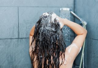 woman washing her hair in the shower