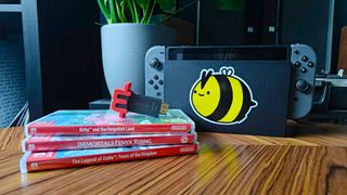 mClassic next to docked Nintendo Switch and games