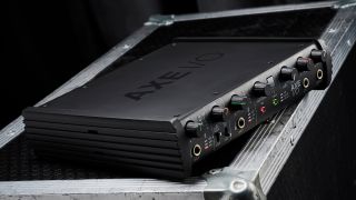 An IK Multimedia AXE I/O audio interface on a black flight case