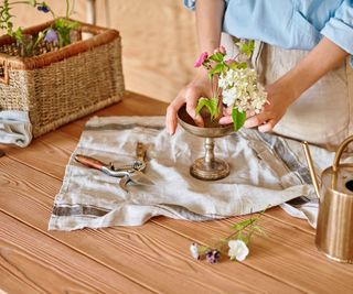 Kenzan in gold footed bowl, scissors and pruner on wooden table