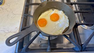 The Lancaster Number 4 cast iron skillet cooking two fried eggs