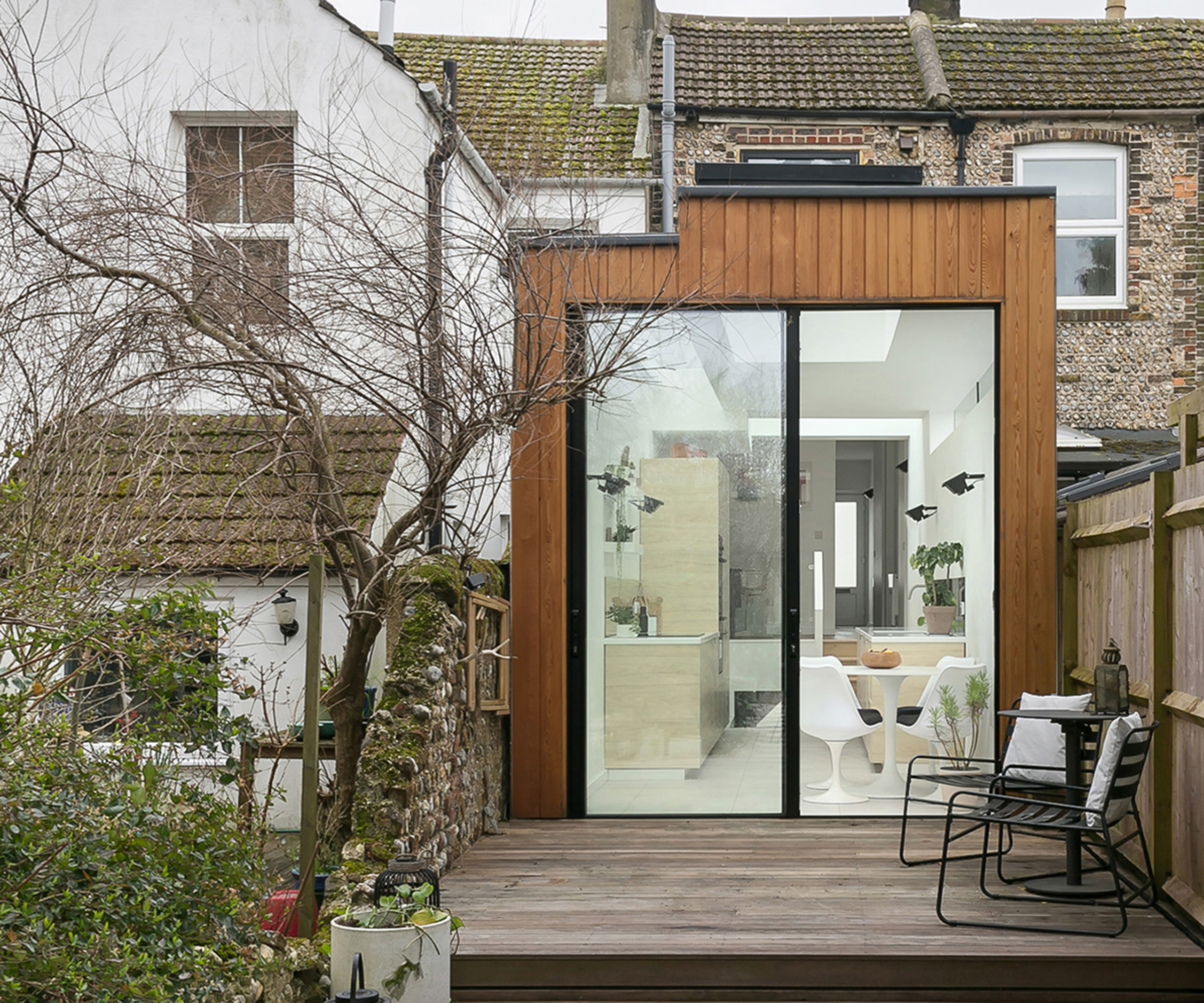 A narrow kitchen extension clad in timber