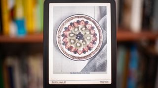 Amazon Kindle Colorsoft Signature edition e-reader showing graphic novels, cookbooks, and fiction, as well as settings