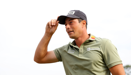 Viktor Hovland touches his cap