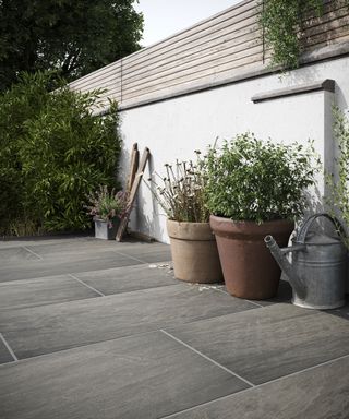 grey paving slabs and a white garden wall