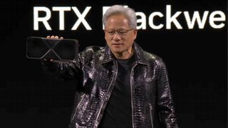 Nvidia CEO Jensen Huang standing on CES 2025 keynote stage holding GeForce RTX GPU