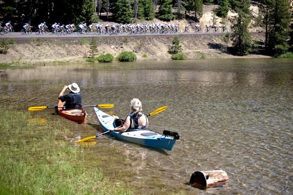 Kayakers take a break to watch the women's peloton pass by.