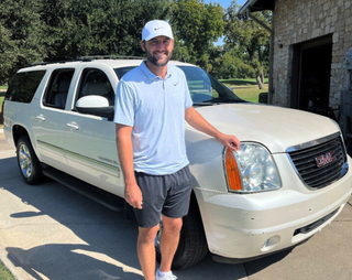 Scottie Scheffler poses in front of his 2012 GMC Yukon XL