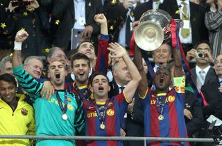 Xavi, centre, and Barcelona celebrate the Champions League trophy