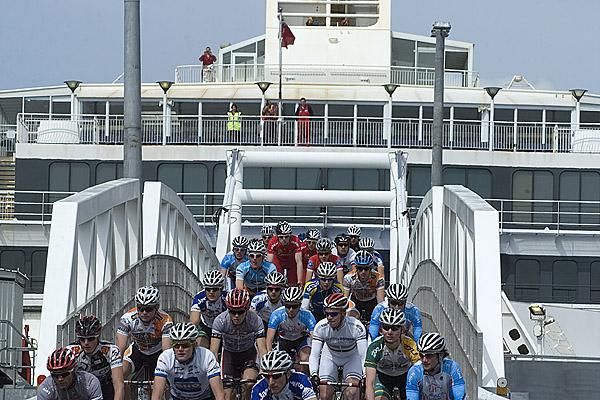 Riders leave the stern of the Spirit of Tasmania for the start of stage one in East Devonport.