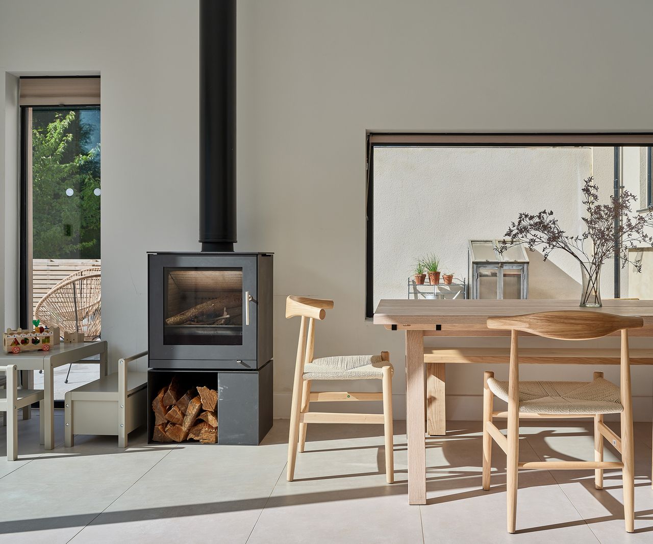 A woodburning stove in the dining room of a contemporary self build home