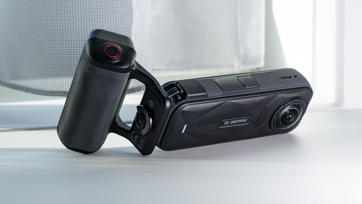 Insta360 X5 Photography Grip attached to the camera, on a plain white surface