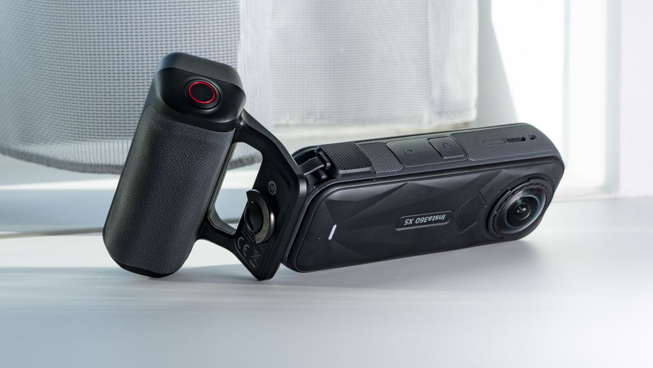 Insta360 X5 Photography Grip attached to the camera, on a plain white surface