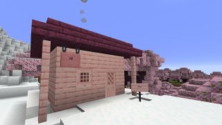 Miencraft - a house made of pink cherry blossom wood in a snowy biome beside a pink sign that reads "hi!"