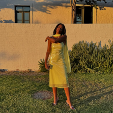 @chrissyford wearing a yellow sequin dress