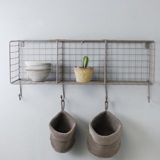 small wire rack storage shelf with plant pots and baskets