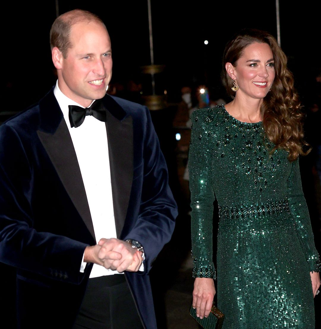 Kate Middleton wearing a green beaded gown walking next to Prince William in a tux
