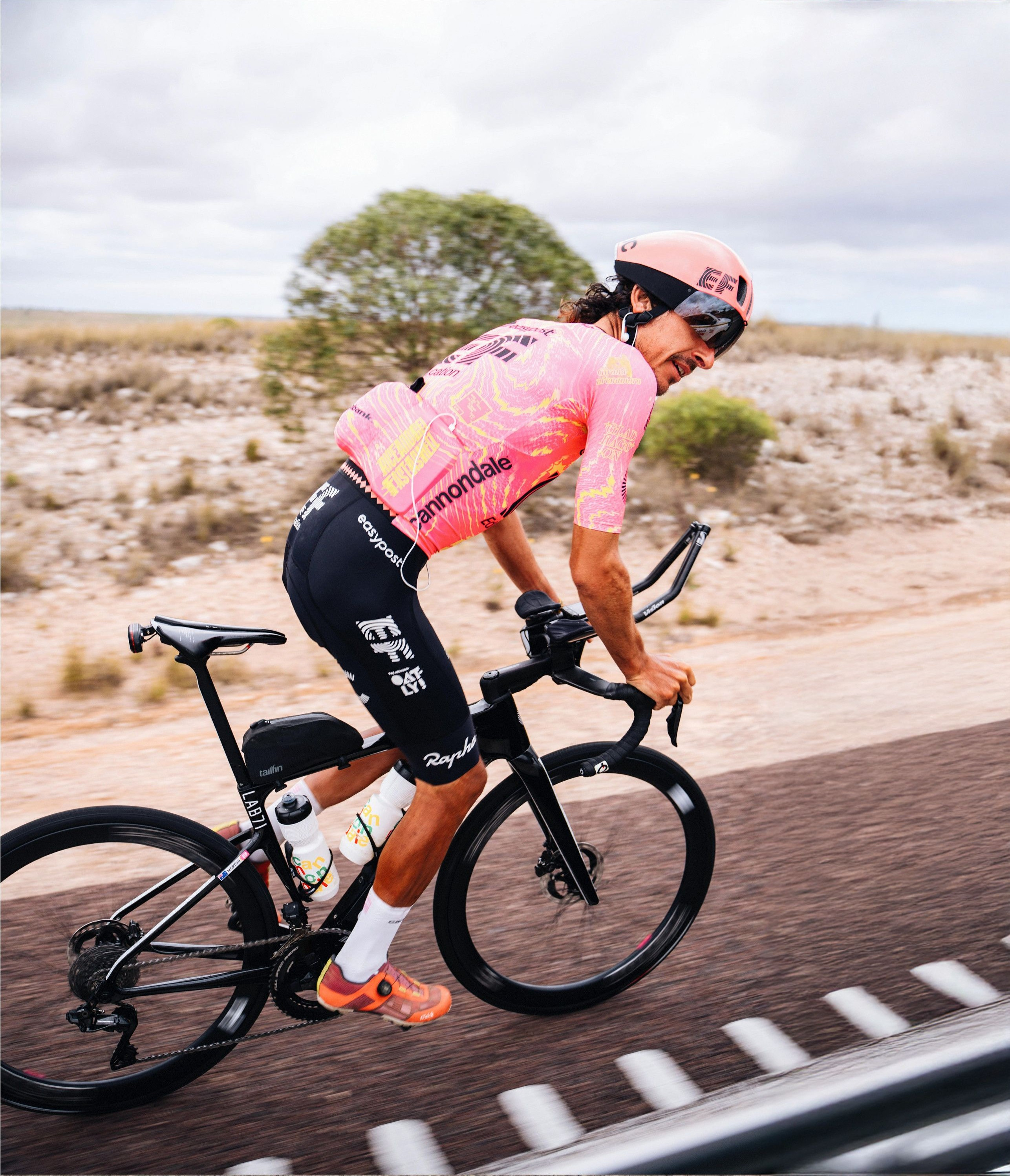 Lachlan Morton riding a Cannondale Synapse on a tarmac road