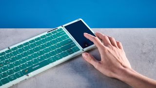 Seenda Foldable Bluetooth Keyboard with Touchpad pictured in front of a blue background.