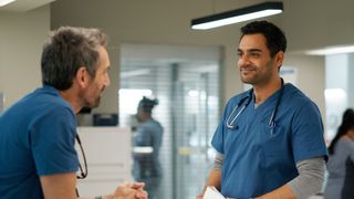Gord Rand as Dr. Mark Novak and Hamza Haq as Dr. Bashir Hamed talking in Transplant season 3